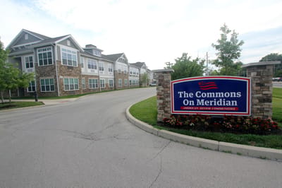 Exterior view of The Commons on Meridian building with logo