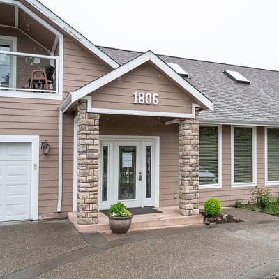 Exterior view of the facility entrance with stone pillars