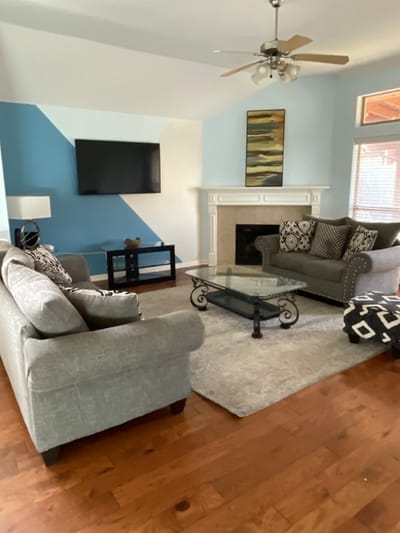 Bright common area with seating and a fireplace