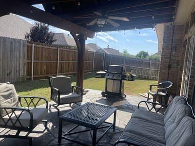 Outdoor patio area with seating and grill