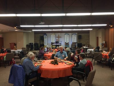 Residents enjoying a meal during an event in the common area
