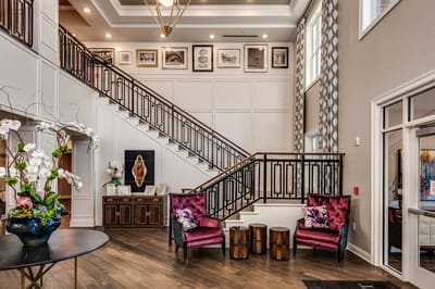 Elegant lobby with seating and decorative stairs