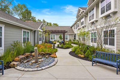 A serene outdoor courtyard with seating and landscaping