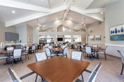 Bright dining area with tables and chairs arranged