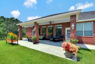 Outdoor patio area with seating and flowers