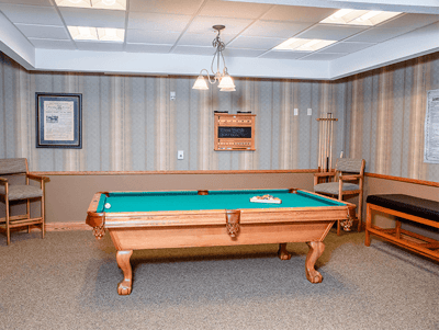 Interior billiards room with a pool table and seating