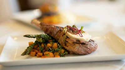Plated gourmet meal with lamb and vegetables