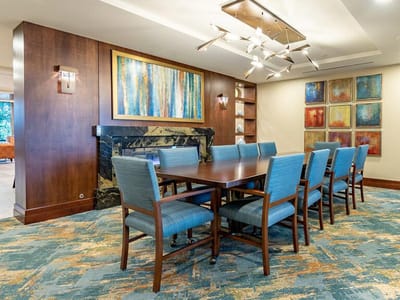Bright common area with a large table and artwork
