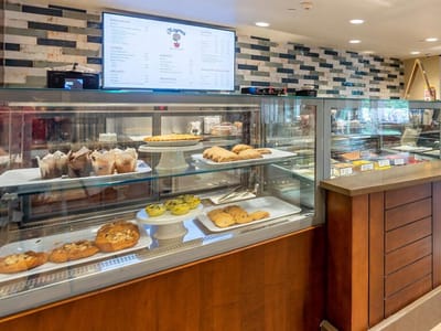 Well-stocked dessert display case in the dining area