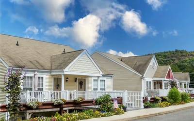 Exterior view of a senior living facility with gardens