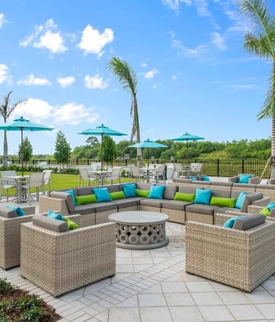 Outdoor seating area with lush greenery and umbrellas