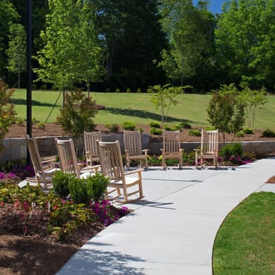 Outdoor seating area with rocking chairs in a garden