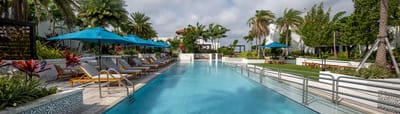 Beautiful outdoor swimming pool with lounge chairs and umbrellas