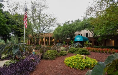 Exterior view of a beautifully landscaped senior living facility