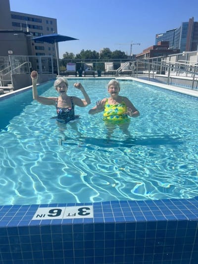 Two residents enjoying swimming pool activity