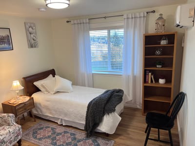 Cozy private room with bed and bookshelf