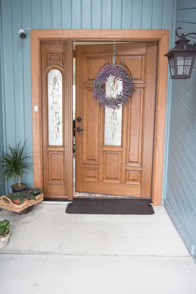 Front entrance with a decorative door and wreath