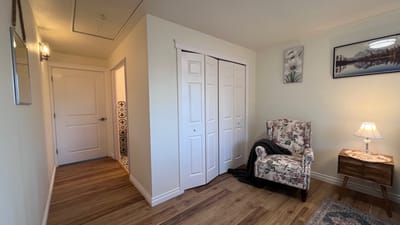Cozy corner in a resident's room with a chair and lamp
