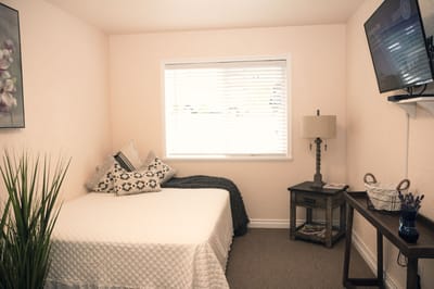 Cozy private resident room with bed and TV