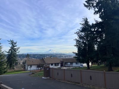 Exterior view of Harbor View Adult Family Home with mountains in the background