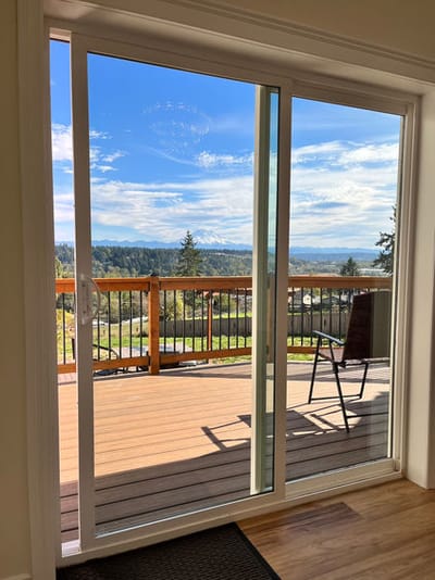 View from the interior showing a deck and scenic landscape