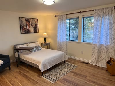 Brightly decorated resident room with bed and window