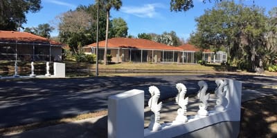 Exterior view of a senior living facility with gardens