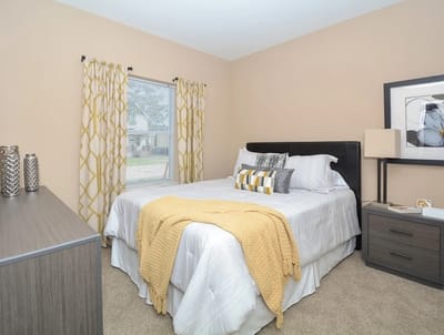 Well-furnished bedroom with warm colors and natural light