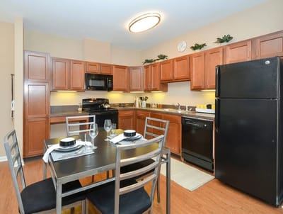 Bright kitchen area with dining table and appliances