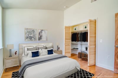 Brightly decorated private resident room with bed and closet