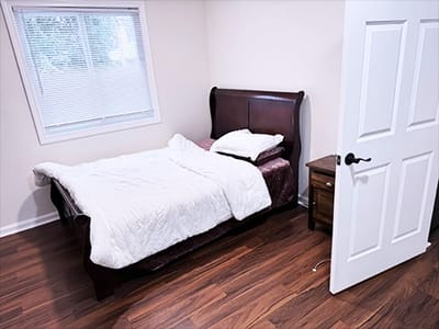 Private resident room with a bed and nightstand