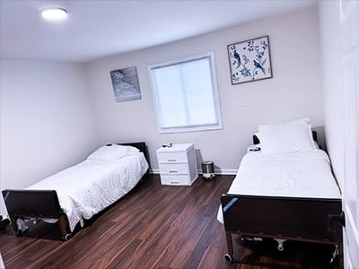 Well-furnished twin bedroom in a care facility