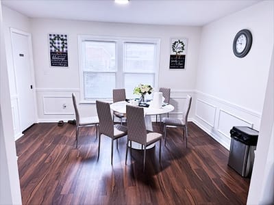 Bright dining room with a circular table and chairs