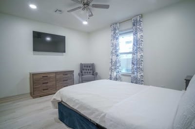 A private resident room with a bed and seating area