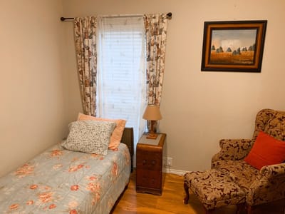 Cozy resident room with bed and chair