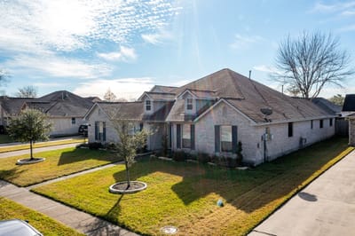 Exterior view of a single-story building and yard