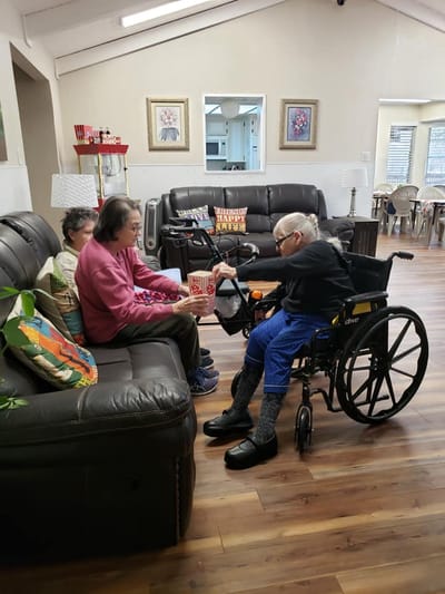Residents enjoying popcorn in a cozy common area