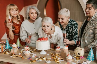 Residents celebrating with cake and drinks at a party