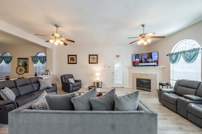Bright common area with comfortable seating and a TV.