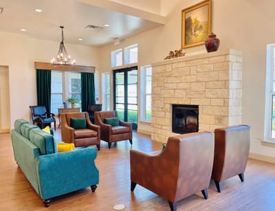 Bright common area with seating and fireplace