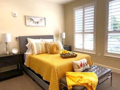Brightly decorated resident room with yellow accents
