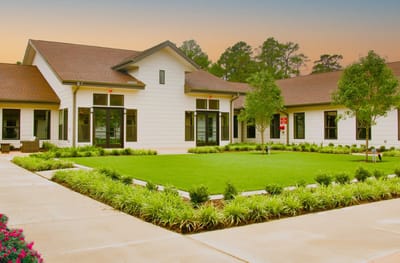 Exterior view of The Bradford Memory Care facility with landscaping