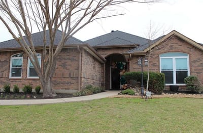 Exterior view of a senior living facility with landscaping