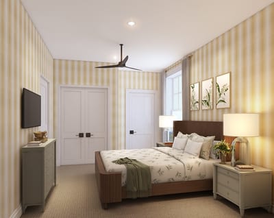 Bright, well-decorated resident room with a bed and artwork