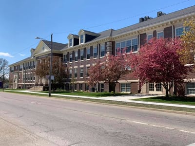 Exterior view of Tiger Senior Apartments with cherry blossom trees