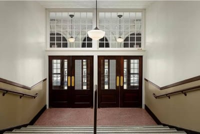 Interior staircase leading to entrance doors
