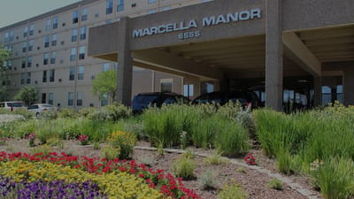 Exterior view of Marcella Manor Apartments with landscaping