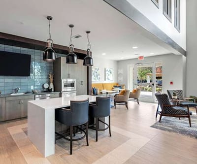 Bright, modern common area with seating and kitchen