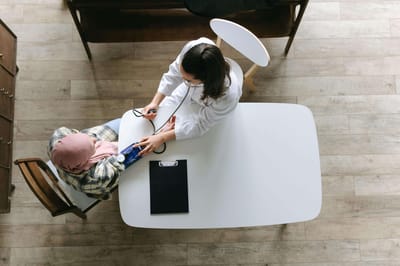 A healthcare professional checking a patient's blood pressure