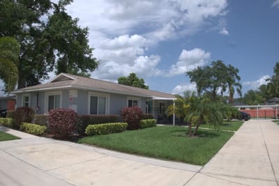 Exterior view of a senior living facility with landscaping